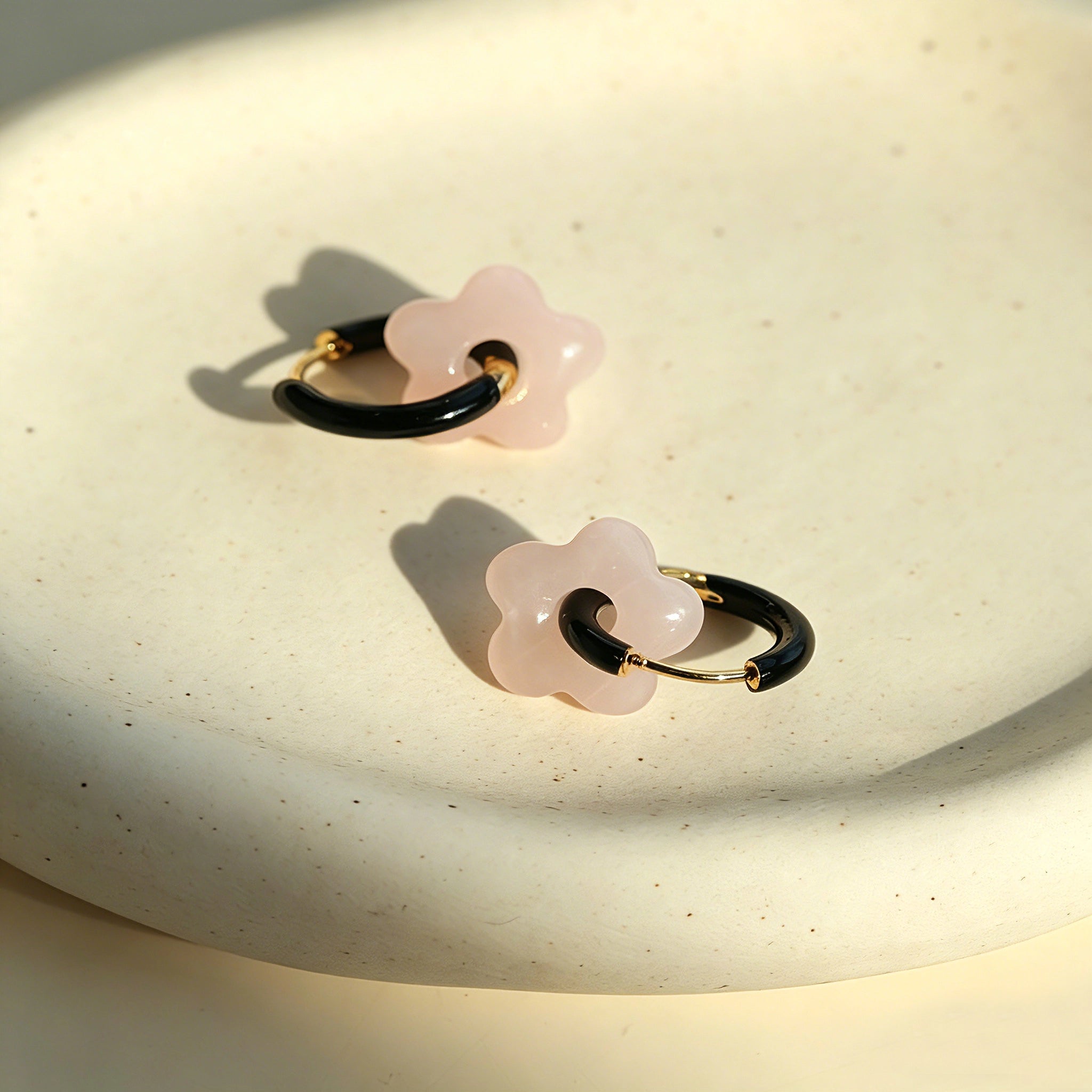 These summer candy-colored hoop earrings feature cute carved natural stone flower pendants paired with glossy enamel-coated metal hoops. They come in a vibrant palette of playful bright hues, creating a fresh, sweet and youthful summery style. The minimalist huggie hoop structure with delicate floral charms makes them lightweight and versatile for daily casual wear.