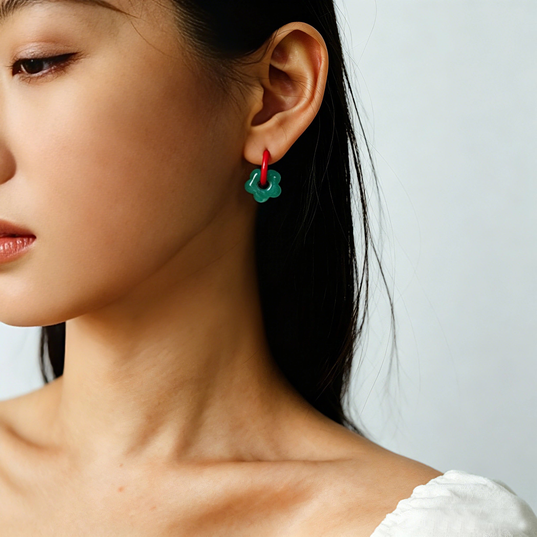These summer candy-colored hoop earrings feature cute carved natural stone flower pendants paired with glossy enamel-coated metal hoops. They come in a vibrant palette of playful bright hues, creating a fresh, sweet and youthful summery style. The minimalist huggie hoop structure with delicate floral charms makes them lightweight and versatile for daily casual wear.