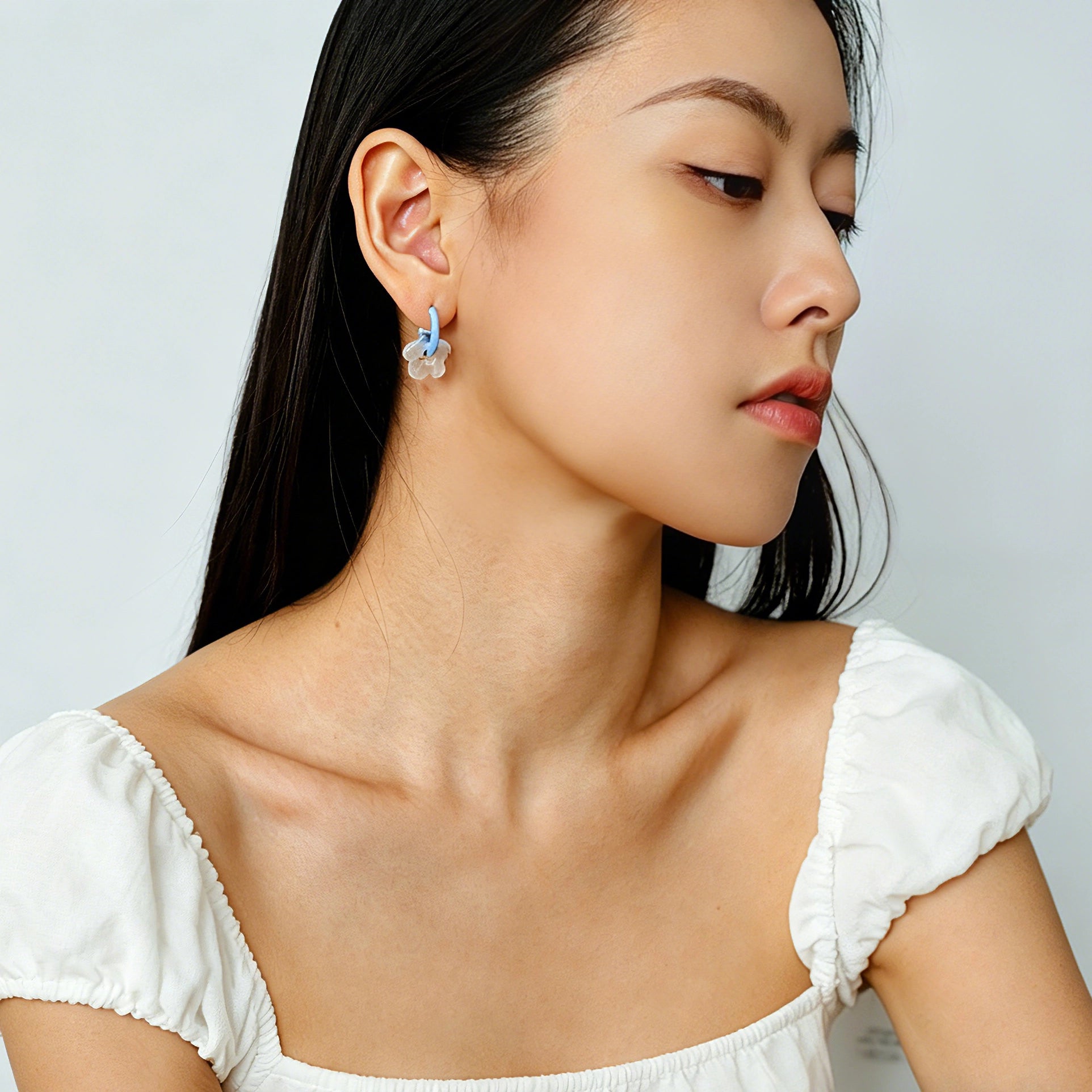 These summer candy-colored hoop earrings feature cute carved natural stone flower pendants paired with glossy enamel-coated metal hoops. They come in a vibrant palette of playful bright hues, creating a fresh, sweet and youthful summery style. The minimalist huggie hoop structure with delicate floral charms makes them lightweight and versatile for daily casual wear.