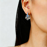 These summer candy-colored hoop earrings feature cute carved natural stone flower pendants paired with glossy enamel-coated metal hoops. They come in a vibrant palette of playful bright hues, creating a fresh, sweet and youthful summery style. The minimalist huggie hoop structure with delicate floral charms makes them lightweight and versatile for daily casual wear.