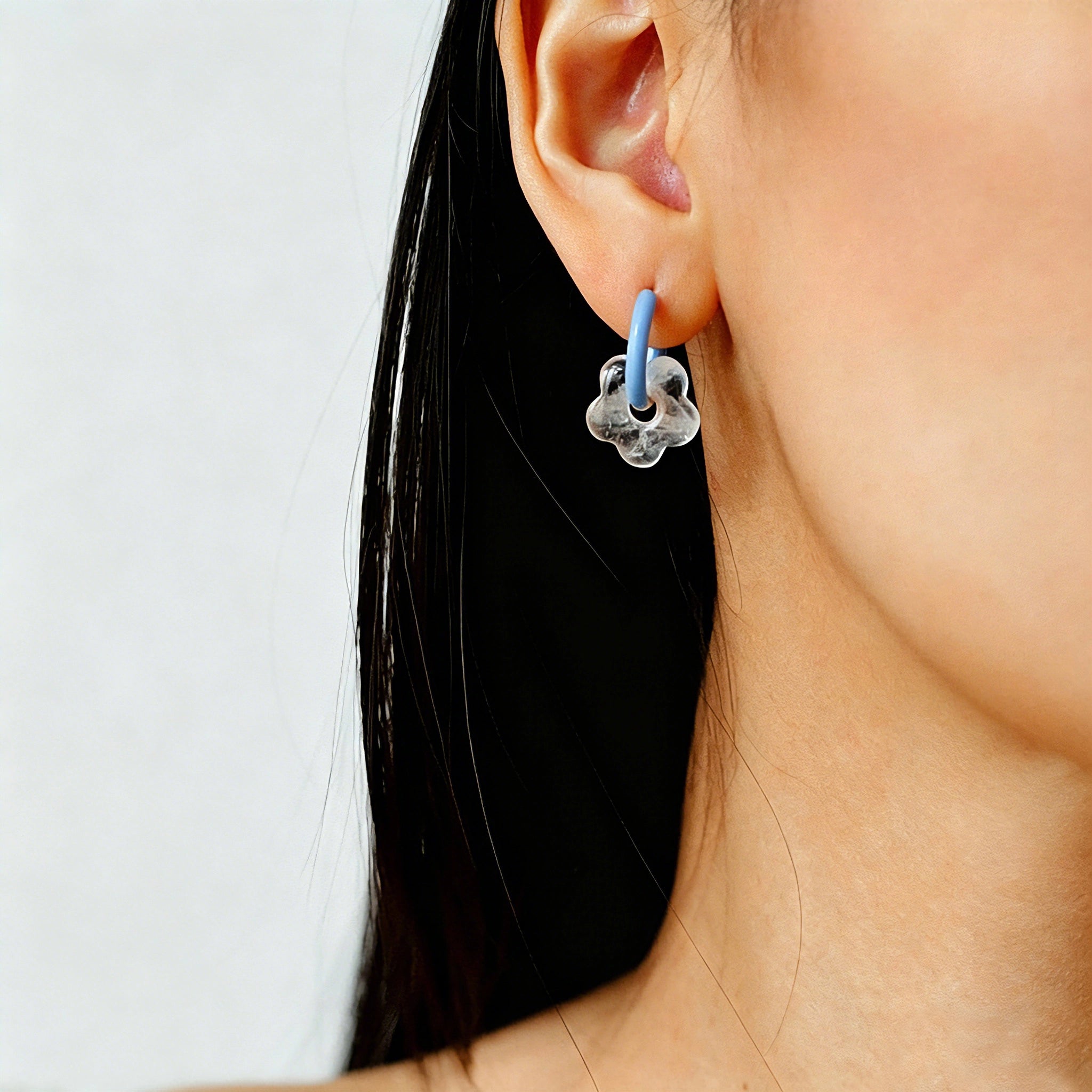 These summer candy-colored hoop earrings feature cute carved natural stone flower pendants paired with glossy enamel-coated metal hoops. They come in a vibrant palette of playful bright hues, creating a fresh, sweet and youthful summery style. The minimalist huggie hoop structure with delicate floral charms makes them lightweight and versatile for daily casual wear.