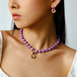 These summer candy-colored hoop earrings feature cute carved natural stone flower pendants paired with glossy enamel-coated metal hoops. They come in a vibrant palette of playful bright hues, creating a fresh, sweet and youthful summery style. The minimalist huggie hoop structure with delicate floral charms makes them lightweight and versatile for daily casual wear.