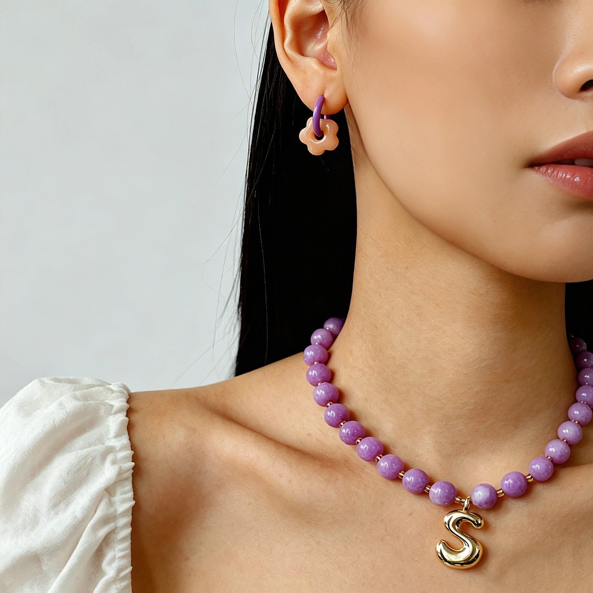 These summer candy-colored hoop earrings feature cute carved natural stone flower pendants paired with glossy enamel-coated metal hoops. They come in a vibrant palette of playful bright hues, creating a fresh, sweet and youthful summery style. The minimalist huggie hoop structure with delicate floral charms makes them lightweight and versatile for daily casual wear.
