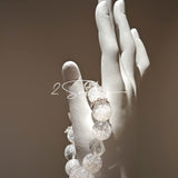 This is a crystal bracelet including white fireworks super seven clear quartzs, pure clear quartzs and raw clear quartz nuggets.