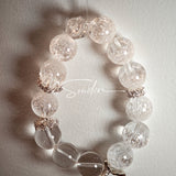 This is a crystal bracelet including white fireworks super seven clear quartzs, pure clear quartzs and raw clear quartz nuggets.
