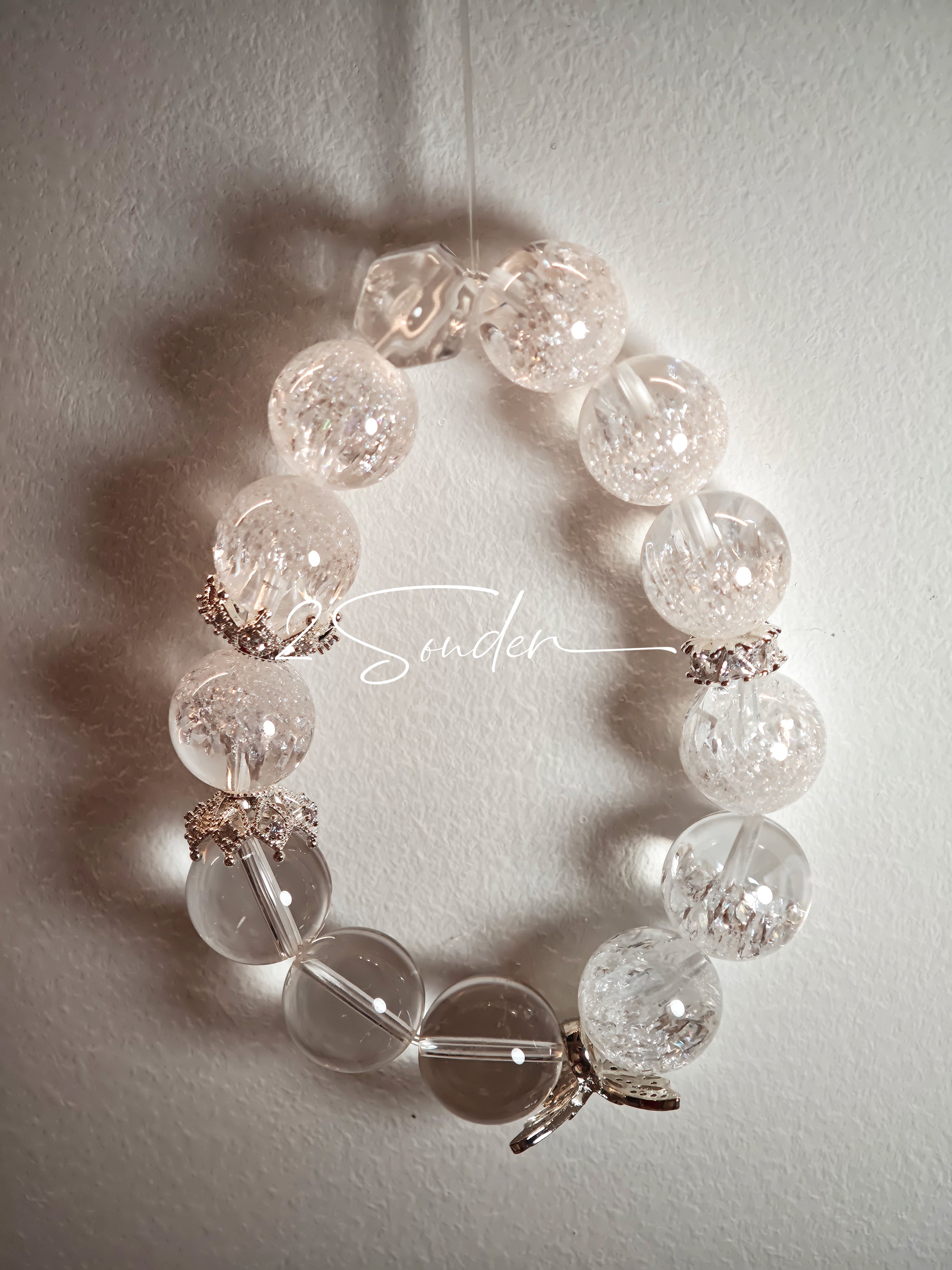 This is a crystal bracelet including white fireworks super seven clear quartzs, pure clear quartzs and raw clear quartz nuggets.
