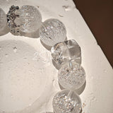 This is a crystal bracelet including white fireworks super seven clear quartzs, pure clear quartzs and raw clear quartz nuggets.