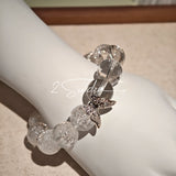 This is a crystal bracelet including white fireworks super seven clear quartzs, pure clear quartzs and raw clear quartz nuggets.
