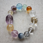This is a rainbow energy bracelet that consists of Aquamarine, Amethyst, Clear Quartz, White Phantom Quartz, Citrine, Prehnite, Golden Healer, and Herkimer Diamond.