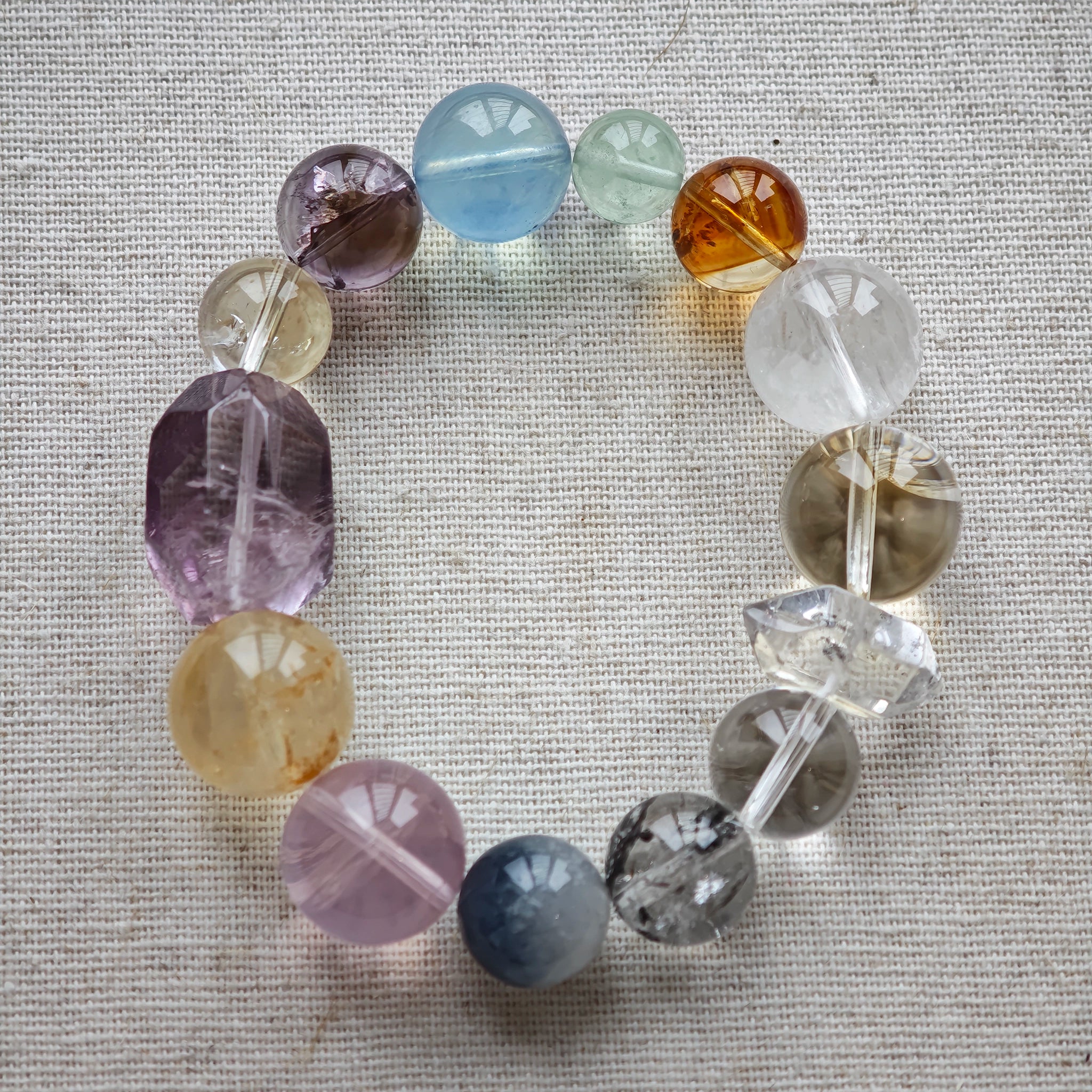 This is a rainbow energy bracelet that consists of Aquamarine, Amethyst, Clear Quartz, White Phantom Quartz, Citrine, Prehnite, Golden Healer, and Herkimer Diamond.