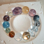 This is a rainbow energy bracelet that consists of Aquamarine, Amethyst, Clear Quartz, White Phantom Quartz, Citrine, Prehnite, Golden Healer, and Herkimer Diamond.