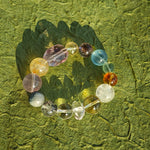 This is a rainbow energy bracelet that consists of Aquamarine, Amethyst, Clear Quartz, White Phantom Quartz, Citrine, Prehnite, Golden Healer, and Herkimer Diamond.