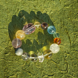 This is a rainbow energy bracelet that consists of Aquamarine, Amethyst, Clear Quartz, White Phantom Quartz, Citrine, Prehnite, Golden Healer, and Herkimer Diamond.