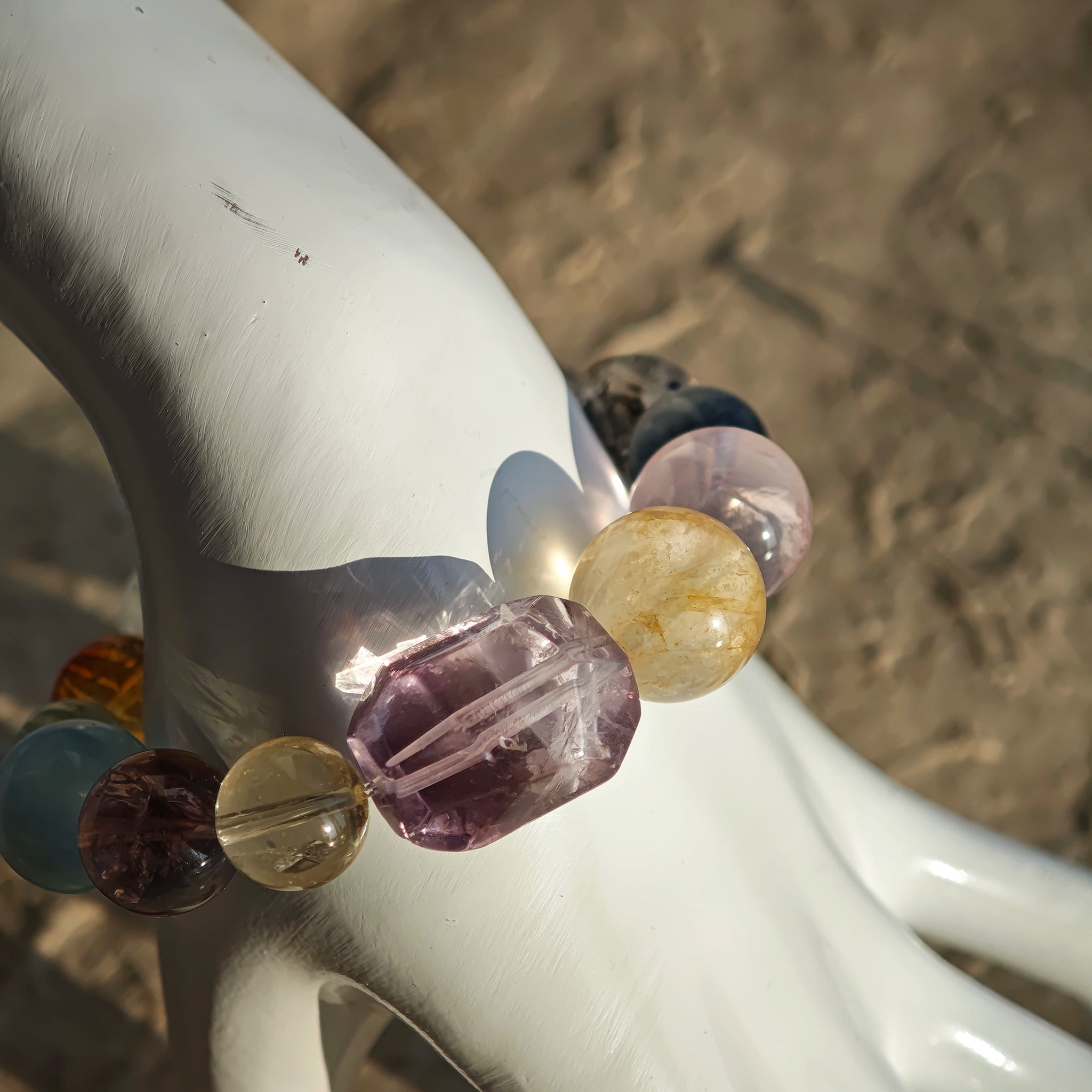This is a rainbow energy bracelet that consists of Aquamarine, Amethyst, Clear Quartz, White Phantom Quartz, Citrine, Prehnite, Golden Healer, and Herkimer Diamond.