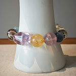 This is a rainbow energy bracelet that consists of Aquamarine, Amethyst, Clear Quartz, White Phantom Quartz, Citrine, Prehnite, Golden Healer, and Herkimer Diamond.