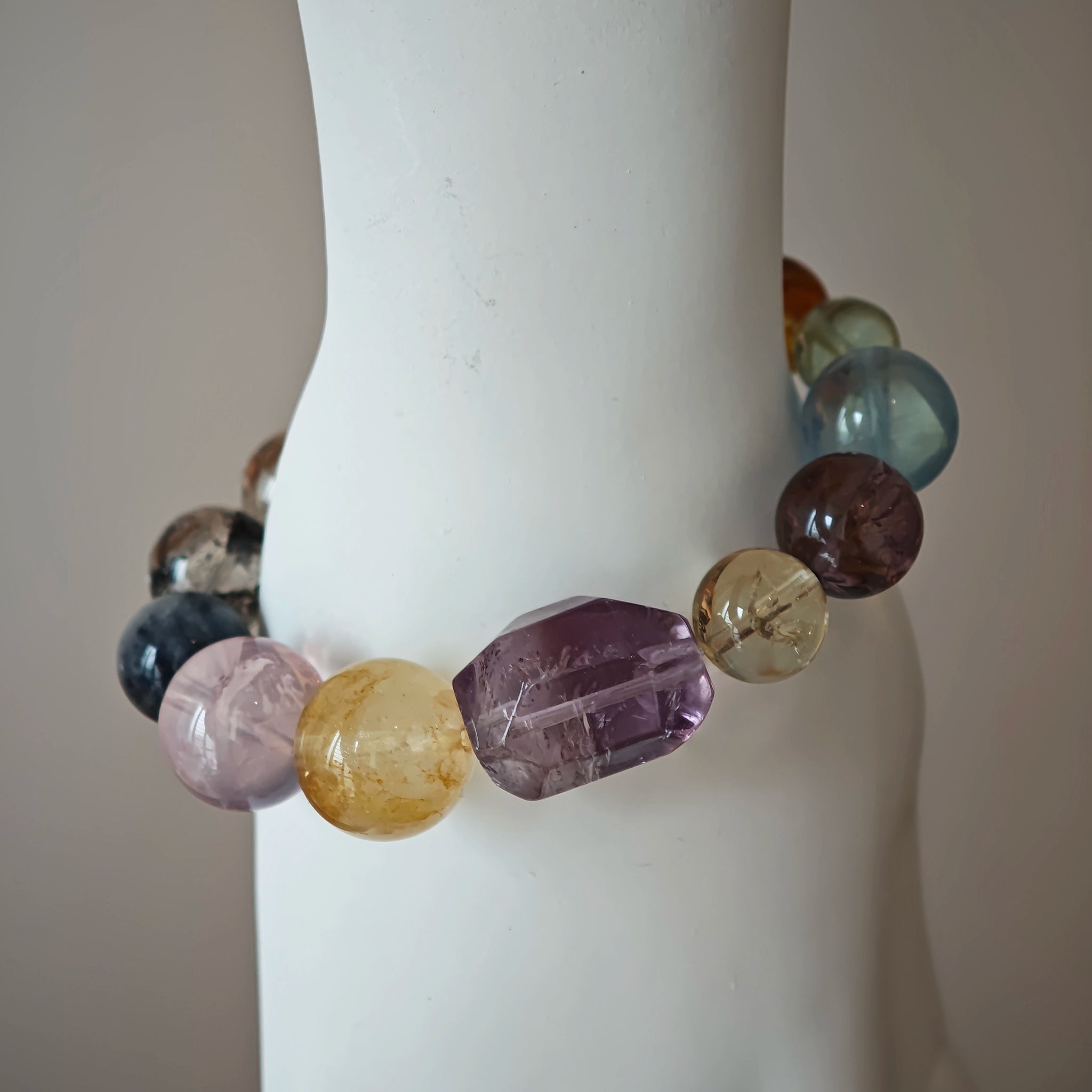 This is a rainbow energy bracelet that consists of Aquamarine, Amethyst, Clear Quartz, White Phantom Quartz, Citrine, Prehnite, Golden Healer, and Herkimer Diamond.
