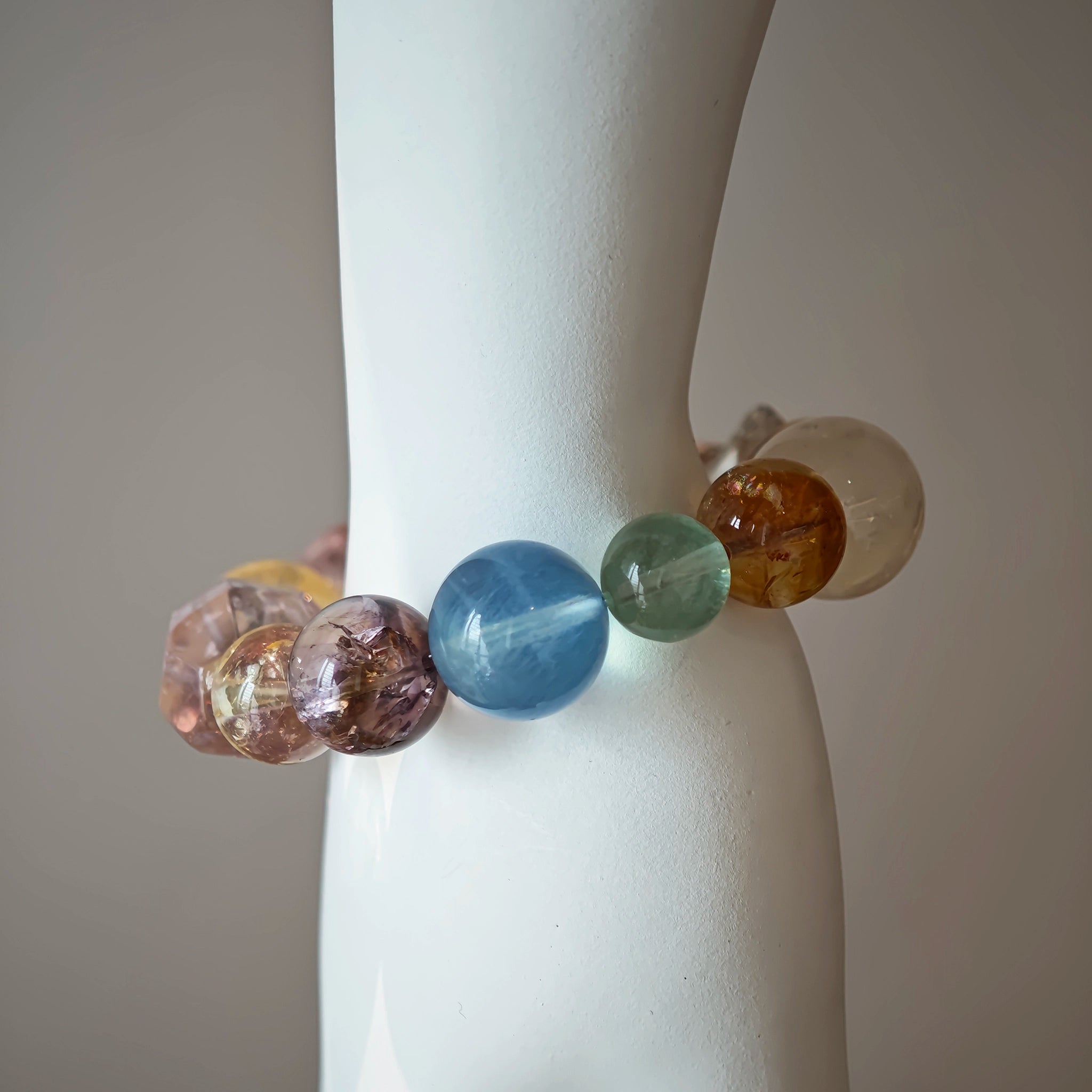 This is a rainbow energy bracelet that consists of Aquamarine, Amethyst, Clear Quartz, White Phantom Quartz, Citrine, Prehnite, Golden Healer, and Herkimer Diamond.