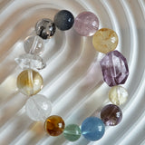 This is a rainbow energy bracelet that consists of Aquamarine, Amethyst, Clear Quartz, White Phantom Quartz, Citrine, Prehnite, Golden Healer, and Herkimer Diamond.