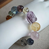 This is a rainbow energy bracelet that consists of Aquamarine, Amethyst, Clear Quartz, White Phantom Quartz, Citrine, Prehnite, Golden Healer, and Herkimer Diamond.