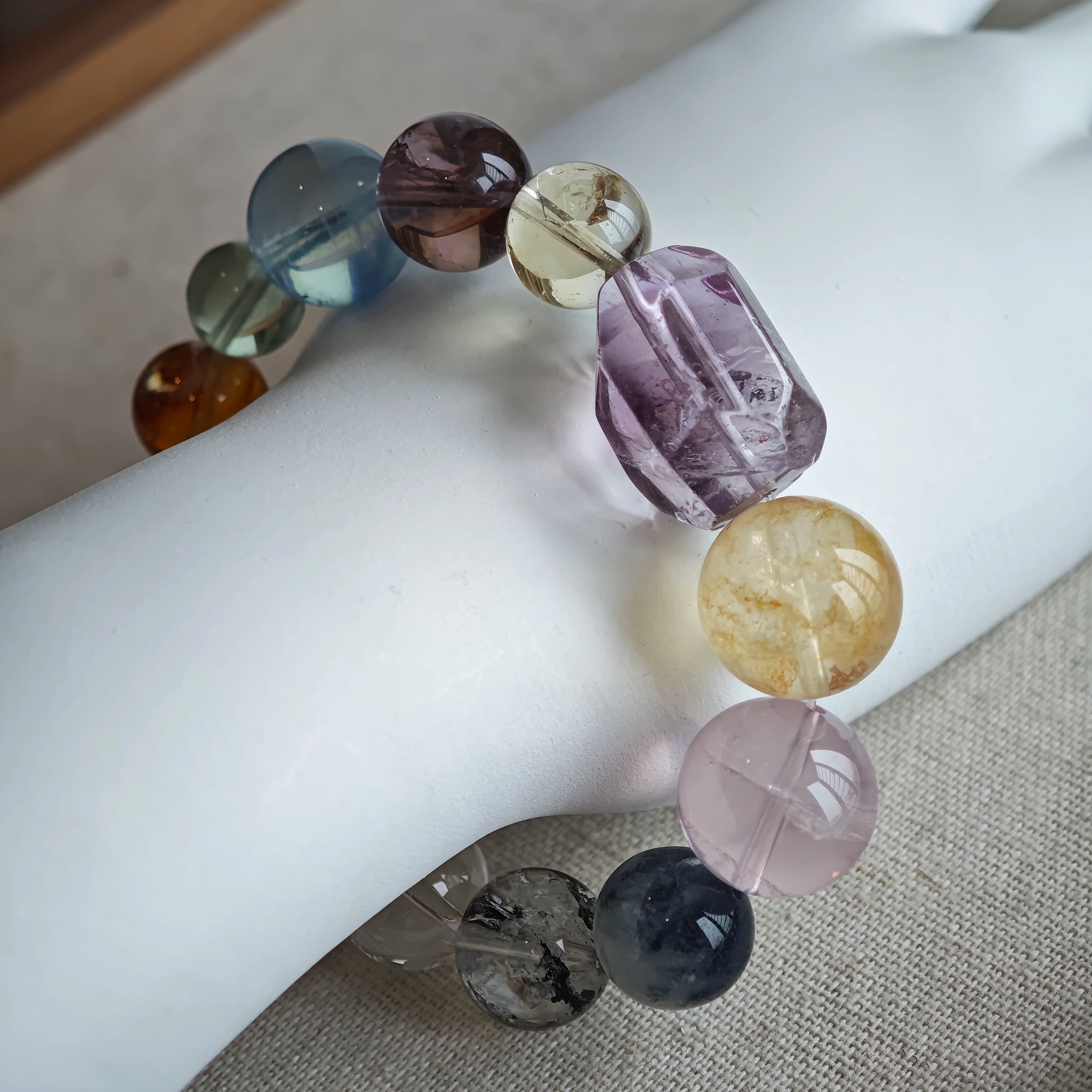 This is a rainbow energy bracelet that consists of Aquamarine, Amethyst, Clear Quartz, White Phantom Quartz, Citrine, Prehnite, Golden Healer, and Herkimer Diamond.