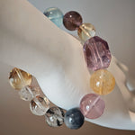 This is a rainbow energy bracelet that consists of Aquamarine, Amethyst, Clear Quartz, White Phantom Quartz, Citrine, Prehnite, Golden Healer, and Herkimer Diamond.