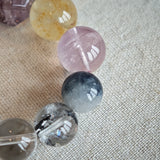 This is a rainbow energy bracelet that consists of Aquamarine, Amethyst, Clear Quartz, White Phantom Quartz, Citrine, Prehnite, Golden Healer, and Herkimer Diamond.