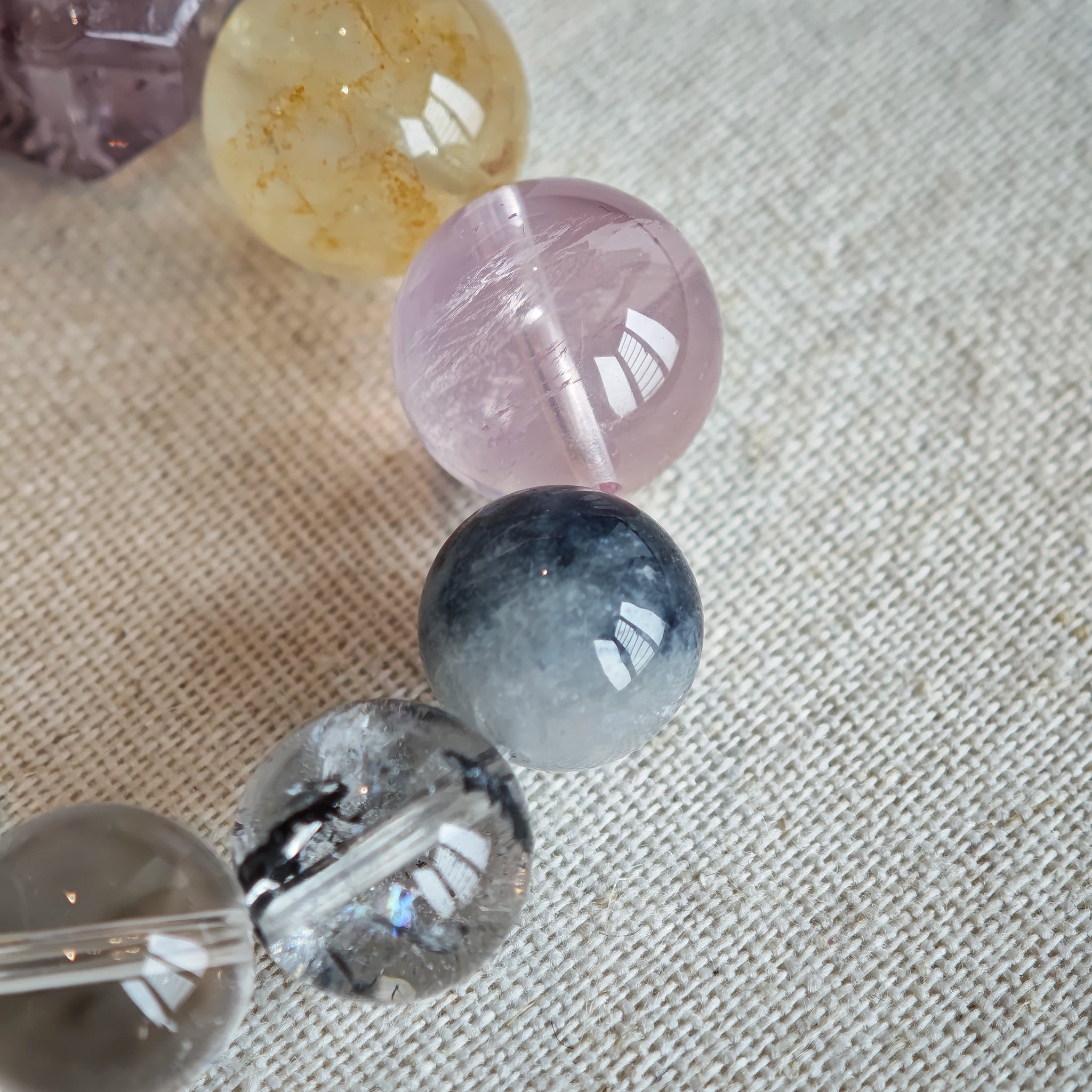 This is a rainbow energy bracelet that consists of Aquamarine, Amethyst, Clear Quartz, White Phantom Quartz, Citrine, Prehnite, Golden Healer, and Herkimer Diamond.