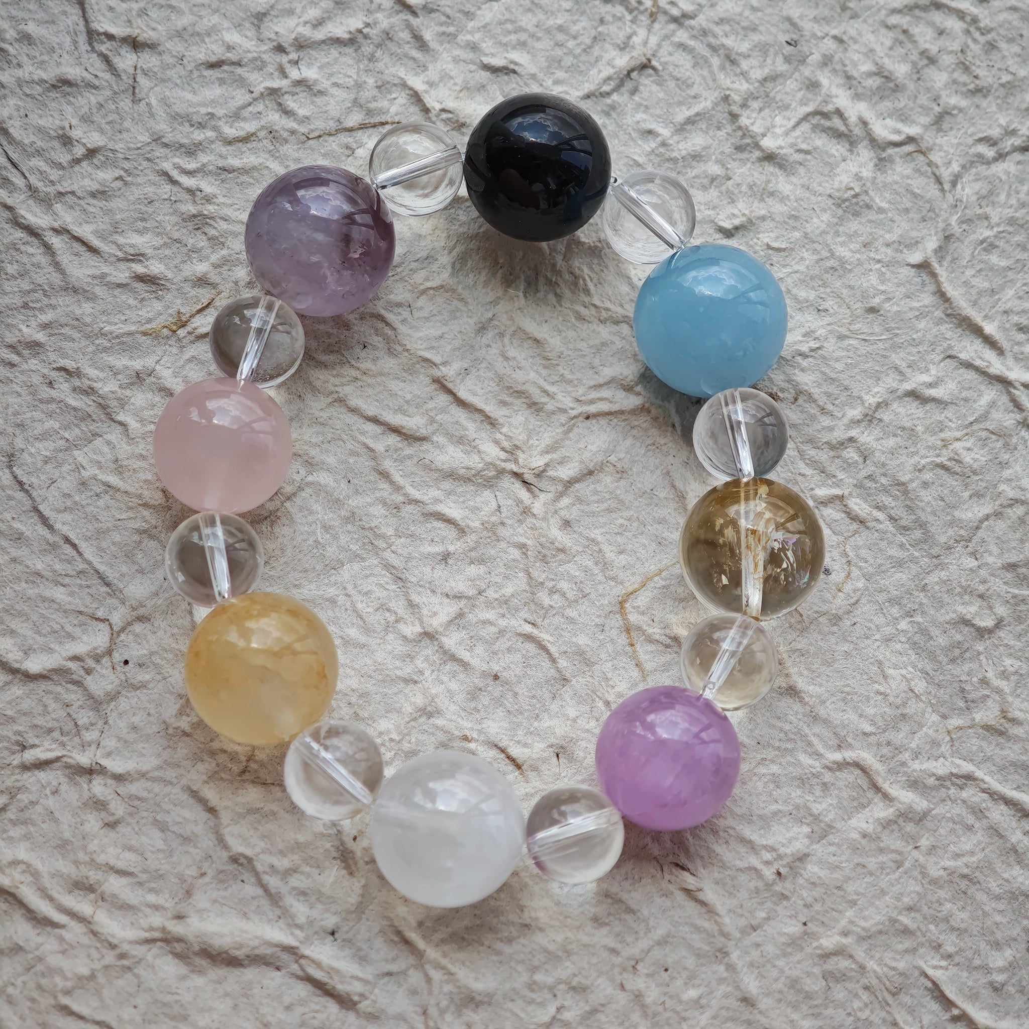 This is a multi-gemstone bracelets consists of Aquamarine, Amethyst, Citrine and White Phantom, etc.