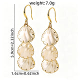 These drop earrings feature three layered natural shell slices with iridescent pearlescent luster. Each shell piece is framed by delicate gold‑tone metal trim for a vintage elegant look. The hook design offers comfortable wear for everyday and special occasions.