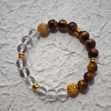 This is a tiger's eye bracelet with clear quartz and gold-plated copper spacer.