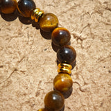 This is a tiger's eye bracelet with clear quartz and gold-plated copper spacer.