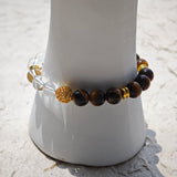 This is a tiger's eye bracelet with clear quartz and gold-plated copper spacer.