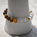This is a tiger's eye bracelet with clear quartz and gold-plated copper spacer.