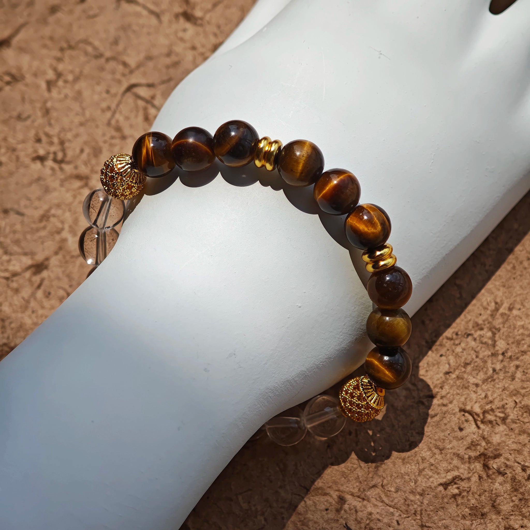 This is a tiger's eye bracelet with clear quartz and gold-plated copper spacer.