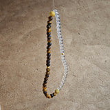 This is a necklace with tiger's eye, clear quartz, gold-plated spacer and elastic cord.