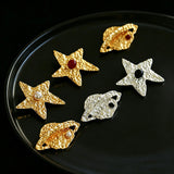 These vintage-style brooches come in star and Saturn-inspired planet shapes, with a hammered, textured finish in gold or silver tone. Each design is accented with a central gemstone, including pearl, red agate, or black onyx, adding a touch of celestial charm to any outfit.