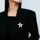 These vintage-style brooches come in star and Saturn-inspired planet shapes, with a hammered, textured finish in gold or silver tone. Each design is accented with a central gemstone, including pearl, red agate, or black onyx, adding a touch of celestial charm to any outfit.