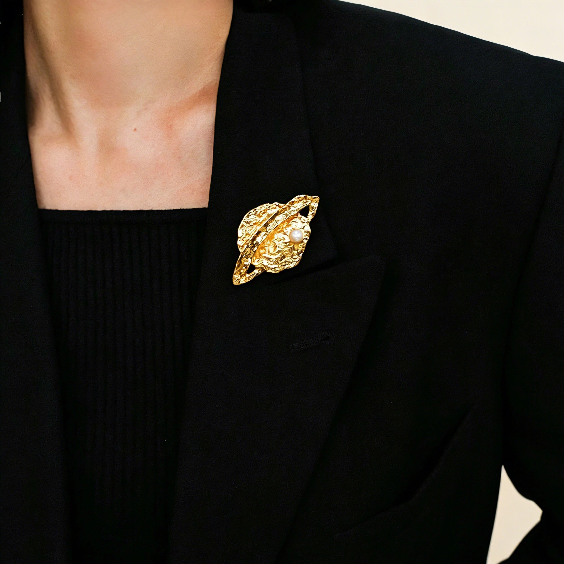 These vintage-style brooches come in star and Saturn-inspired planet shapes, with a hammered, textured finish in gold or silver tone. Each design is accented with a central gemstone, including pearl, red agate, or black onyx, adding a touch of celestial charm to any outfit.