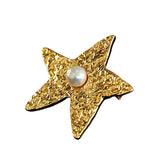 These vintage-style brooches come in star and Saturn-inspired planet shapes, with a hammered, textured finish in gold or silver tone. Each design is accented with a central gemstone, including pearl, red agate, or black onyx, adding a touch of celestial charm to any outfit.