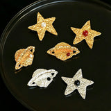 These vintage-style brooches come in star and Saturn-inspired planet shapes, with a hammered, textured finish in gold or silver tone. Each design is accented with a central gemstone, including pearl, red agate, or black onyx, adding a touch of celestial charm to any outfit.