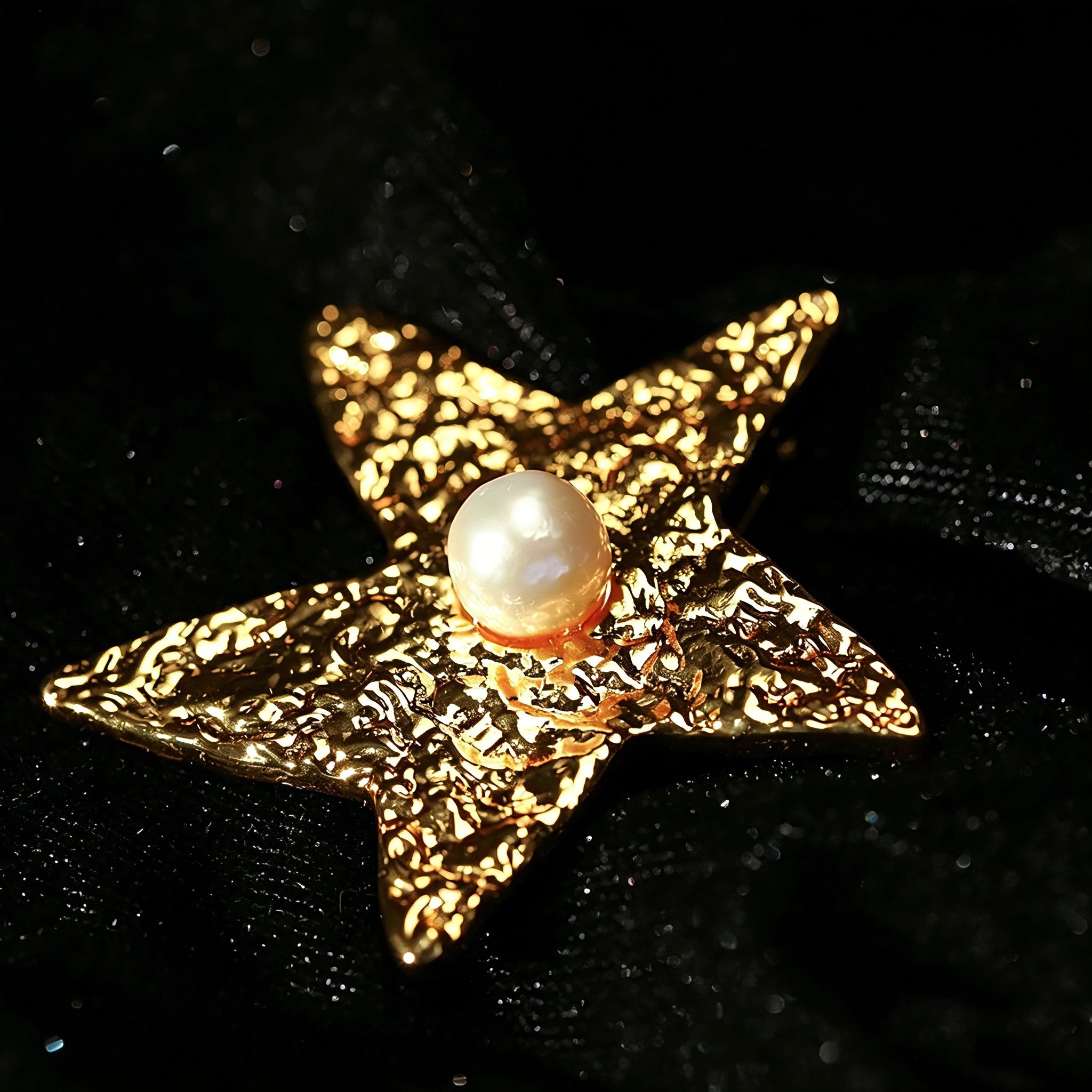 These vintage-style brooches come in star and Saturn-inspired planet shapes, with a hammered, textured finish in gold or silver tone. Each design is accented with a central gemstone, including pearl, red agate, or black onyx, adding a touch of celestial charm to any outfit.