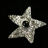 These vintage-style brooches come in star and Saturn-inspired planet shapes, with a hammered, textured finish in gold or silver tone. Each design is accented with a central gemstone, including pearl, red agate, or black onyx, adding a touch of celestial charm to any outfit.