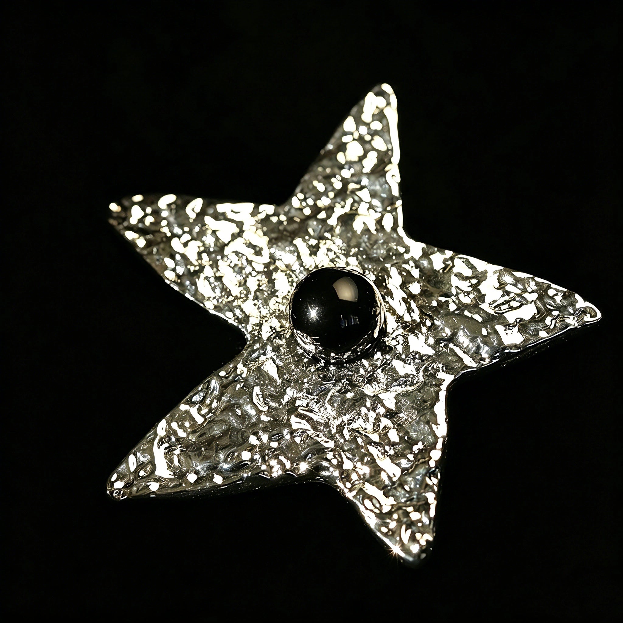 These vintage-style brooches come in star and Saturn-inspired planet shapes, with a hammered, textured finish in gold or silver tone. Each design is accented with a central gemstone, including pearl, red agate, or black onyx, adding a touch of celestial charm to any outfit.