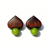 Crafted with dark wood heart‑shaped pieces paired with vivid green grape‑tone stone beads. This stud earring blends retro natural texture and fresh color contrast. It delivers a unique boho‑charm look for daily wear.