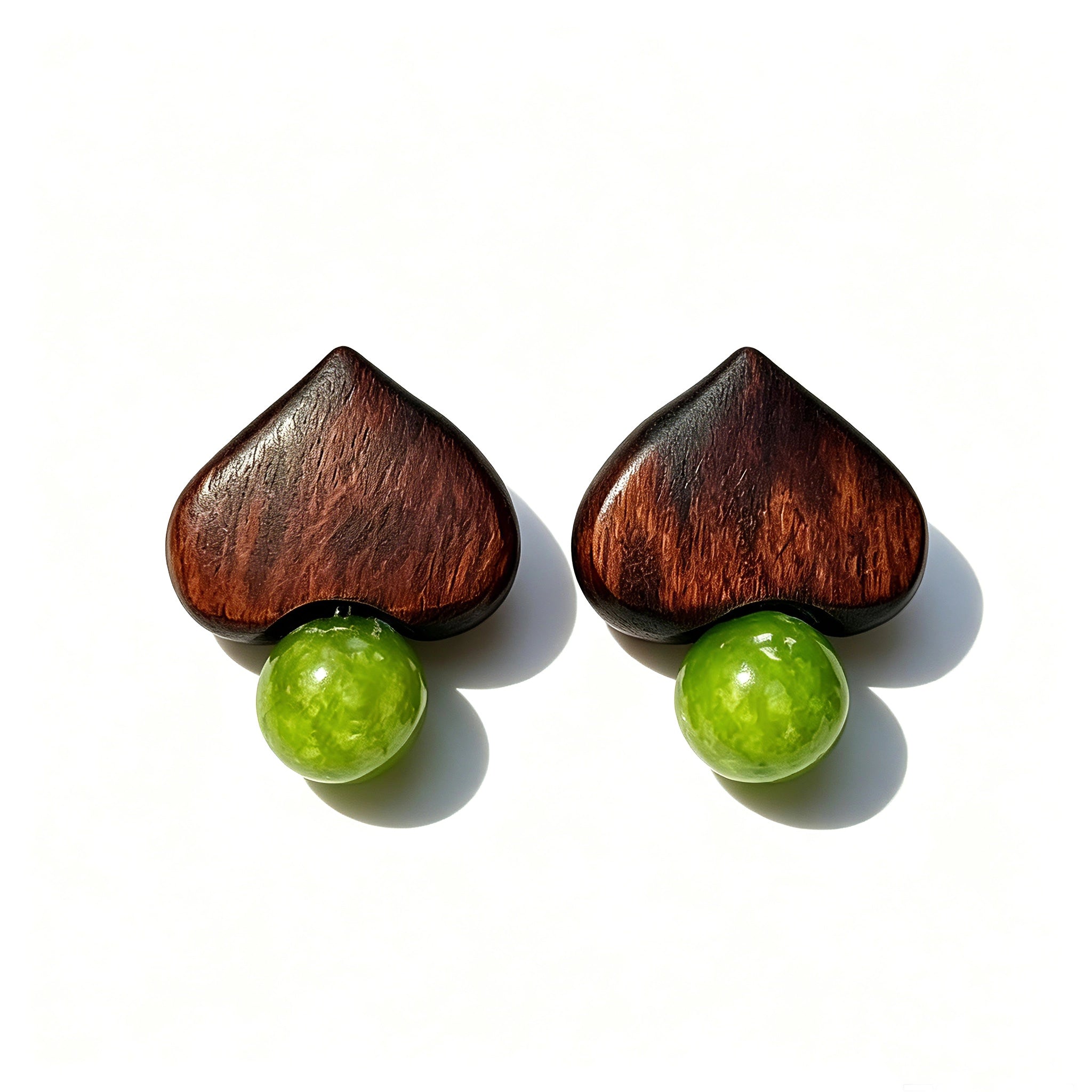 Crafted with dark wood heart‑shaped pieces paired with vivid green grape‑tone stone beads. This stud earring blends retro natural texture and fresh color contrast. It delivers a unique boho‑charm look for daily wear.