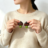 Crafted with dark wood heart‑shaped pieces paired with vivid green grape‑tone stone beads. This stud earring blends retro natural texture and fresh color contrast. It delivers a unique boho‑charm look for daily wear.