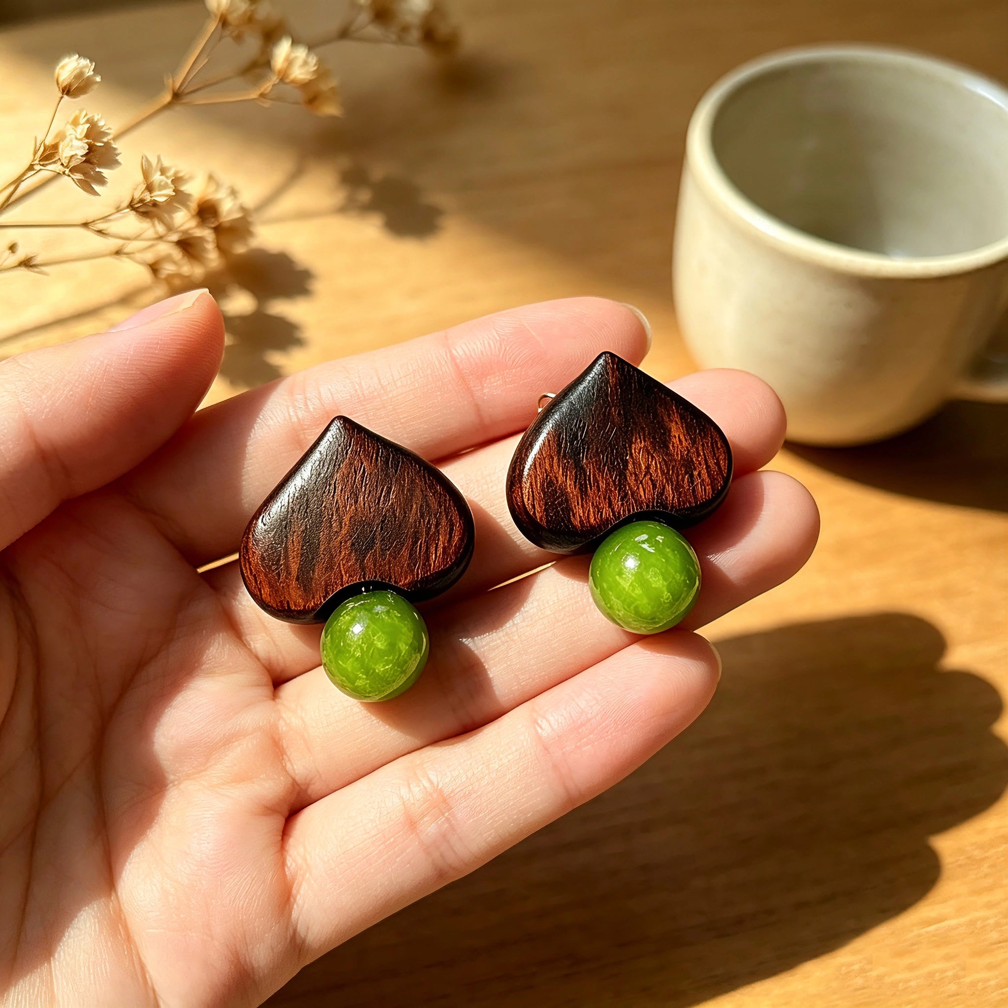 Crafted with dark wood heart‑shaped pieces paired with vivid green grape‑tone stone beads. This stud earring blends retro natural texture and fresh color contrast. It delivers a unique boho‑charm look for daily wear.