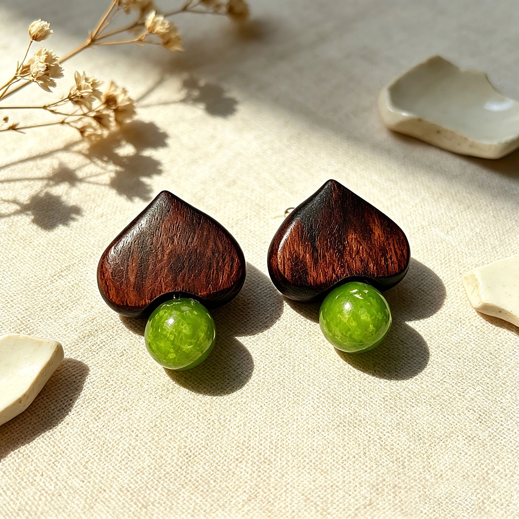 Crafted with dark wood heart‑shaped pieces paired with vivid green grape‑tone stone beads. This stud earring blends retro natural texture and fresh color contrast. It delivers a unique boho‑charm look for daily wear.