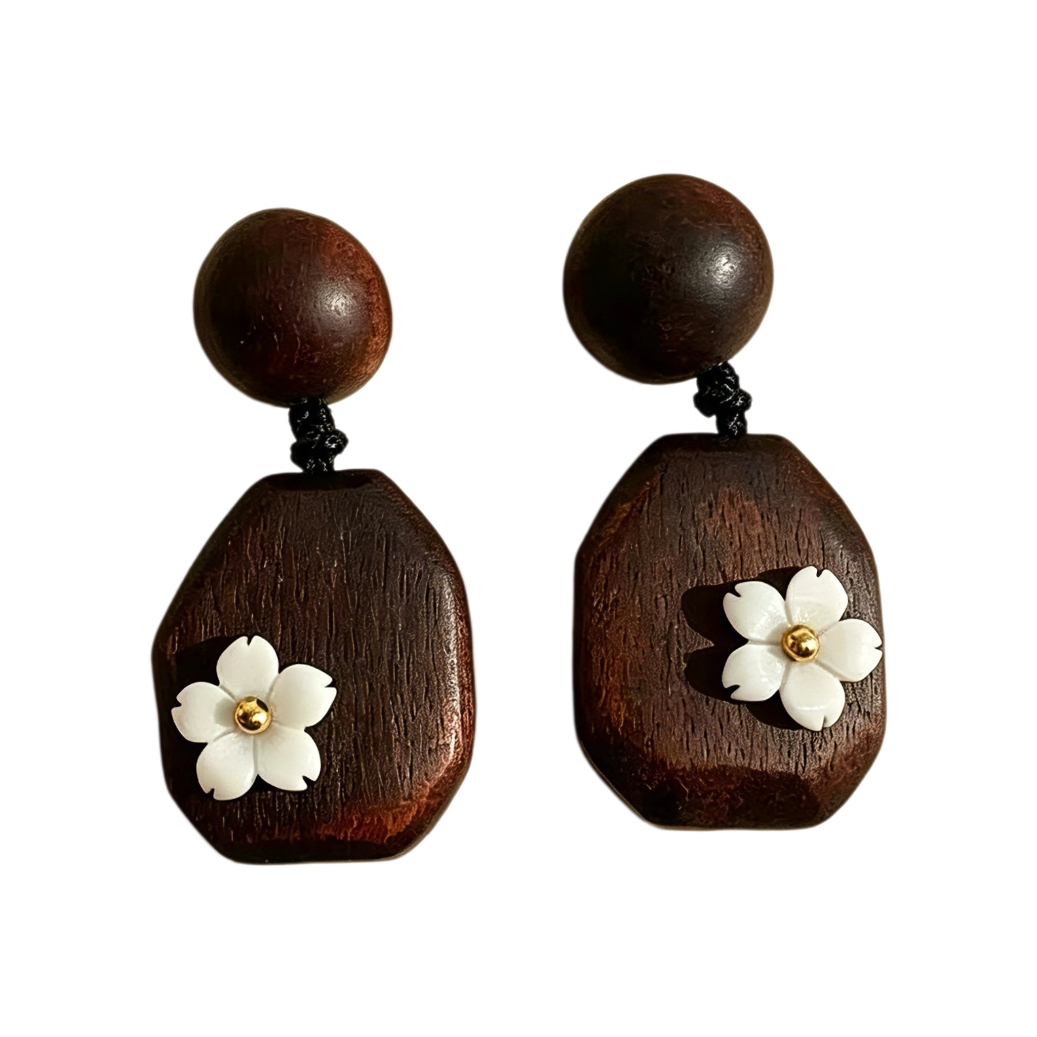 Crafted from vintage‑style dark wood, these drop earrings feature delicate small white flower accents with golden centers. Natural wood grain brings warm retro texture, suspended by black knotted cord for a soft boho‑charm look. They are lightweight statement pieces perfect for daily and casual styling.
