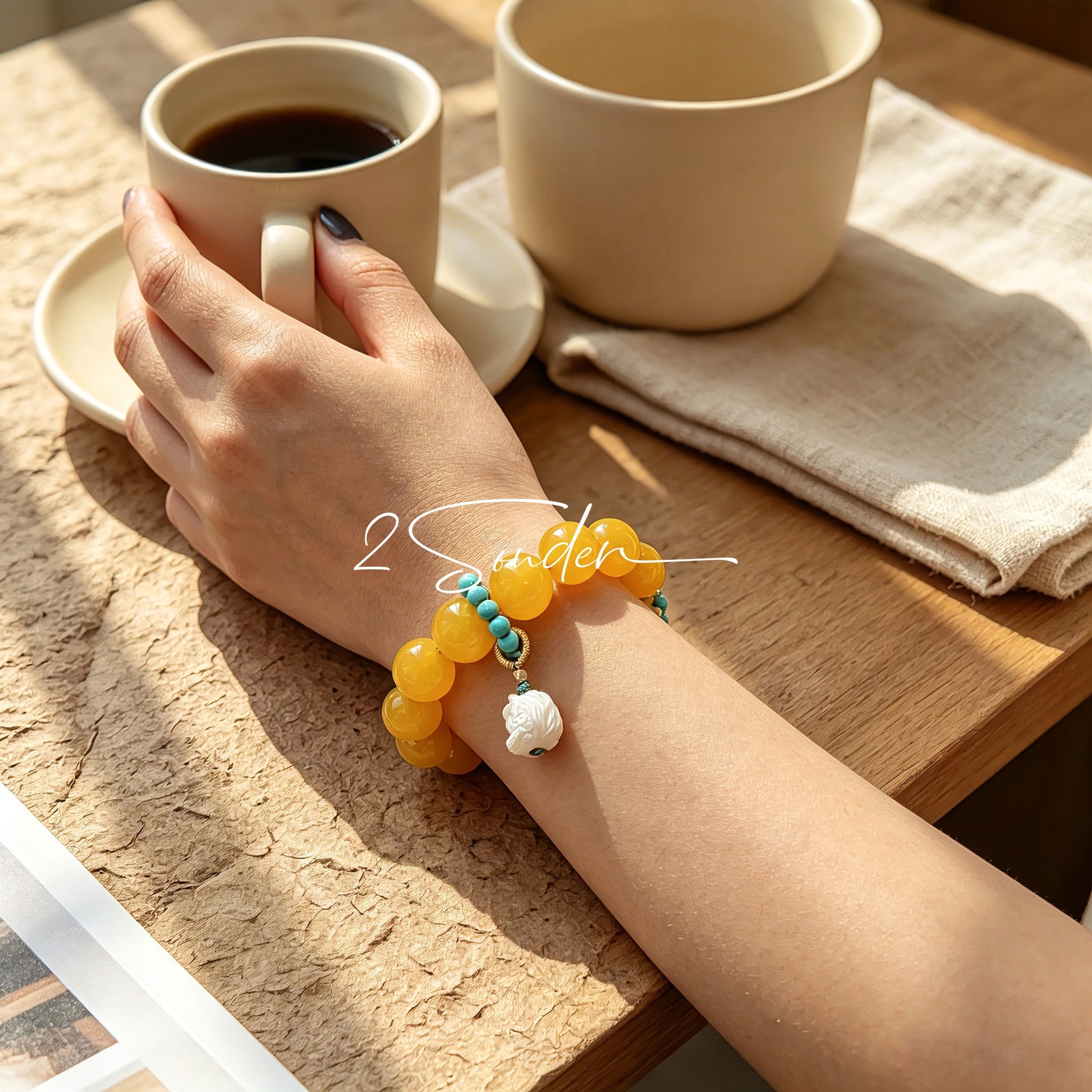 This handcrafted bracelet features glossy 14mm yellow agate beads paired with one white agate bead. It is accented with turquoise beads and finished with a detailed mammoth ivory guardian lion charm, bringing a warm vintage ethnic vibe.